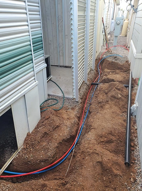 Trenches Dug for New Construction Plumbing Installation Near Buildings