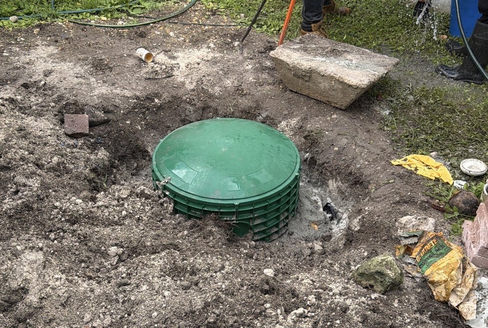 Workers Installing New Drainage System Outdoors