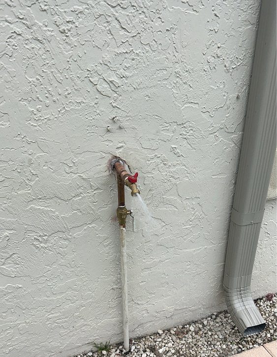 Exterior Wall Pipe Leaking with Water Flow Near Downspout